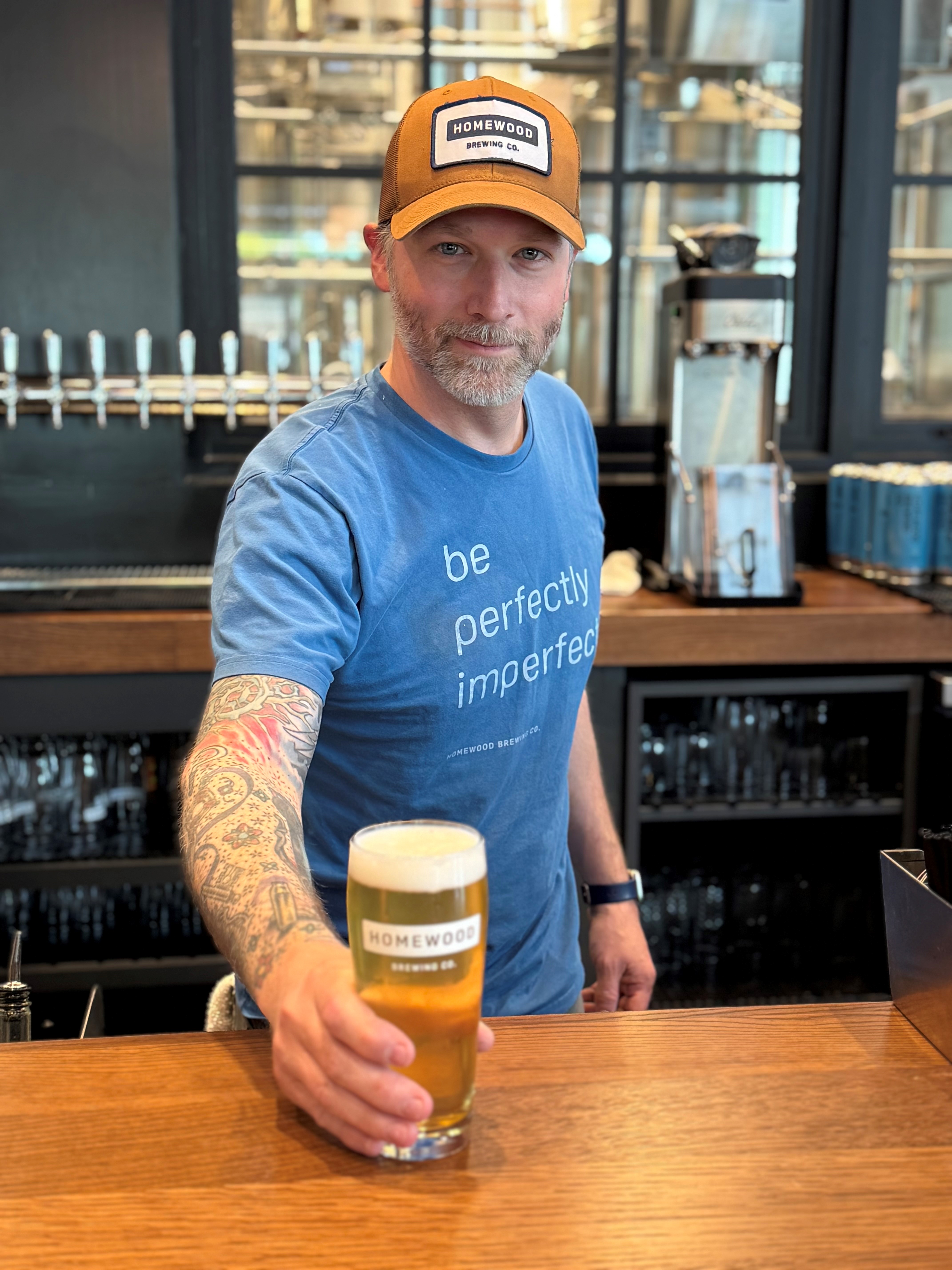 Bar tender serving a Homewood Brewing beer